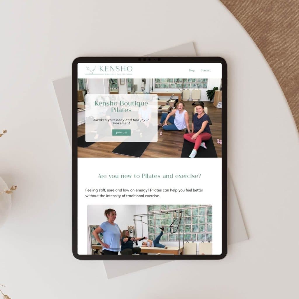 A tablet displays a Pilates studio website called Kensho, featuring images of people exercising and information about classes.