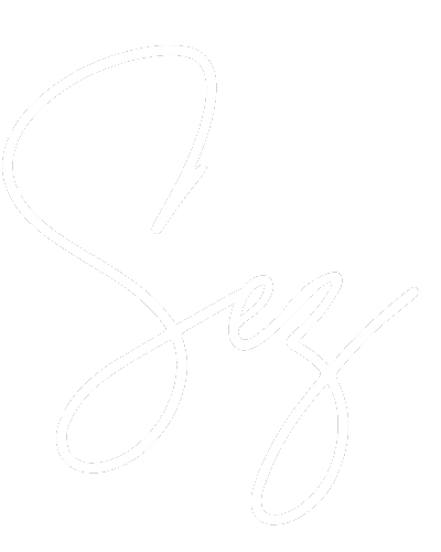 Cursive word "Sexy" written in white on a light grey background.